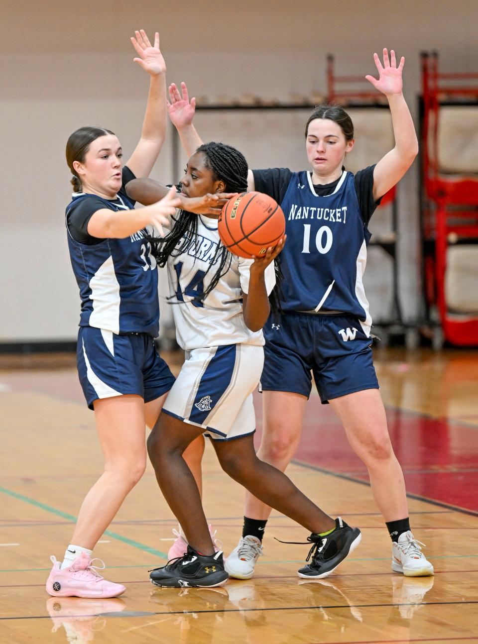 HYANNIS  02/02/24 Maddie Lombardi (left) and Joan Harris of Nantucket pressure Noriann Wray of Sturgis East. Girls basketball
Ron Schloerb/Cape Cod Times