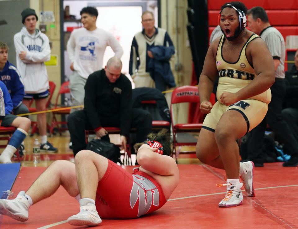 Clarkstown North's Justin Smoot celebrates after pinning  Tappan Zee's Luke Hermann in the 285-pound weight class during the Rockland County wrestling championship at Tappan Zee High School Jan. 21, 2023. 