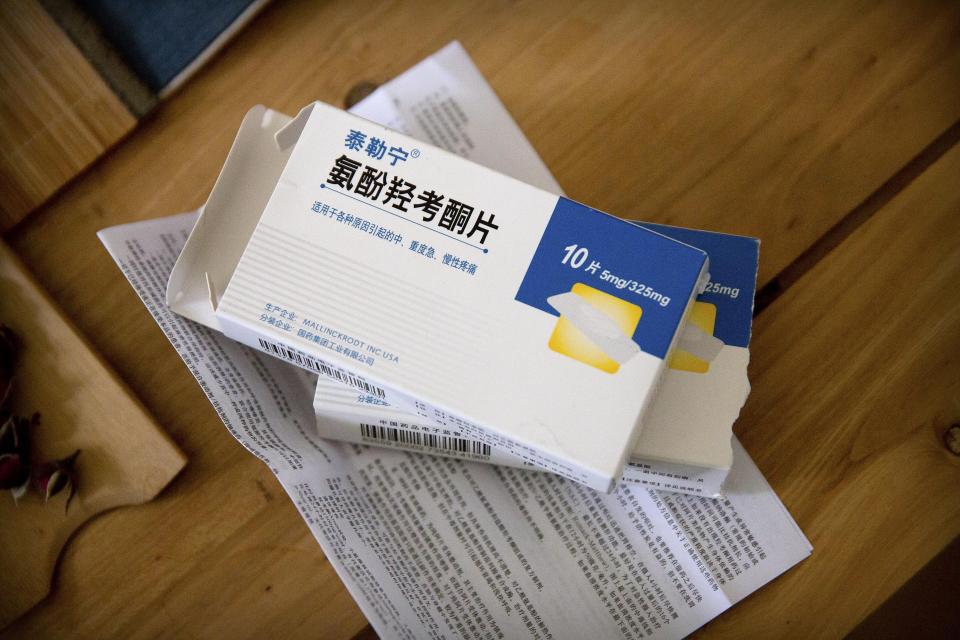 In this March 28, 2019, photo, boxes of Tylox pills Yin Hao, who also goes by Yin Qiang, earlier purchased illicitly sit on a table at a tea house in Xi'an, northwestern China's Shaanxi Province. Officially, pain pill abuse is an American problem, not a Chinese one. But people in China have fallen into opioid abuse the same way many Americans did, through a doctor's prescription. And despite China's strict regulations, online trafficking networks, which facilitated the spread of opioids in the U.S., also exist in China. (AP Photo/Mark Schiefelbein)