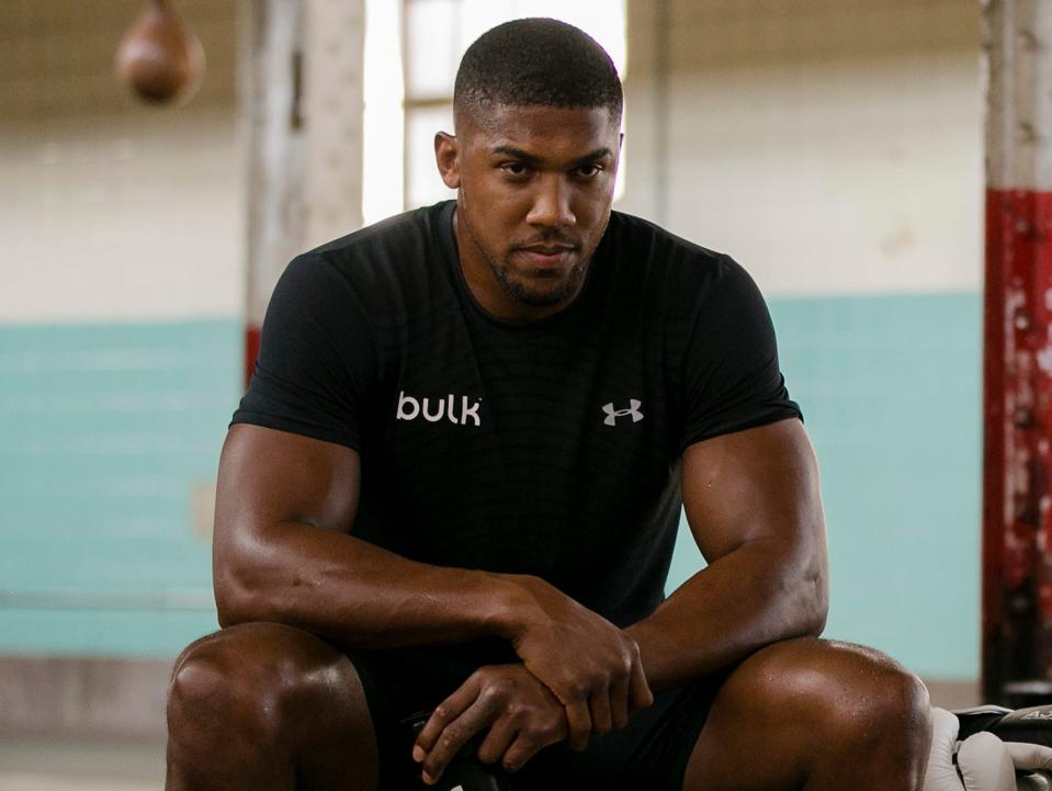 Anthony Joshua sitting in a gym.