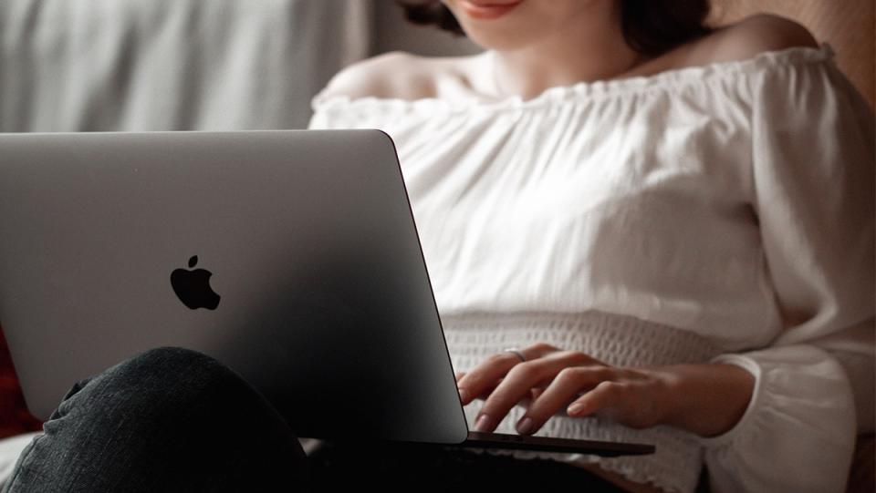 A woman typing on a laptop.