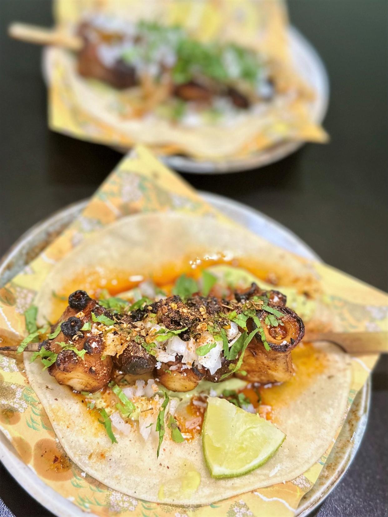 Tacos at Ramen del Barrio come centered with grilled and skewered proteins.
