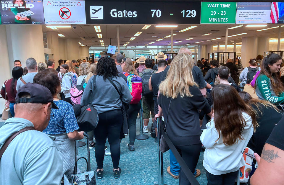 People wait in a TSA screening line at Orlando International Airport three days before Thanksgiving on Nov. 21, 2022. / Credit: Paul Hennessy/SOPA Images/LightRocket via Getty Images