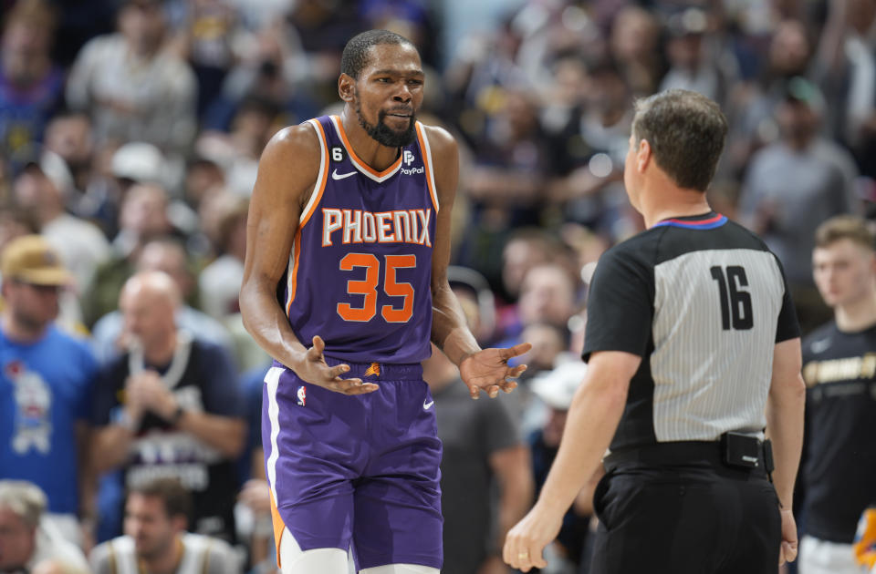 Phoenix Suns forward Kevin Durant, left, argues with referee David Guthrie, who called a foul on Durant during the second half of Game 5 of the team's NBA Western Conference basketball semifinal playoff series against the Denver Nuggets on Tuesday, May 9, 2023, in Denver. (AP Photo/David Zalubowski)