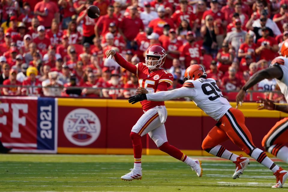 Chiefs quarterback Patrick Mahomes, left, throws as Browns defensive end Myles Garrett defends during the first half Sunday, Sept. 12, 2021, in Kansas City, Mo.