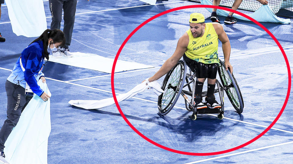 Dylan Alcott, pictured here helping volunteers dry the court at the Paralympics.