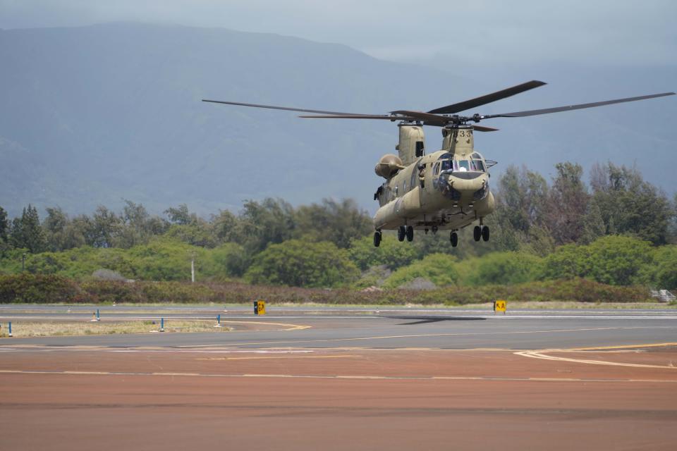 Two Hawaii Army National Guard CH47 Chinook perform aerial water bucket drops on the Island of Maui to assist the fight of wildfires, Maui, Hawaii, August 09, 2023. The two air crews performed 58 total bucket drops in 5 hours in up country Maui totaling over one hundred thousand gallons dropped on the fires. (U.S. National Guard Video by Air Force Master Sgt. Andrew Jackson)