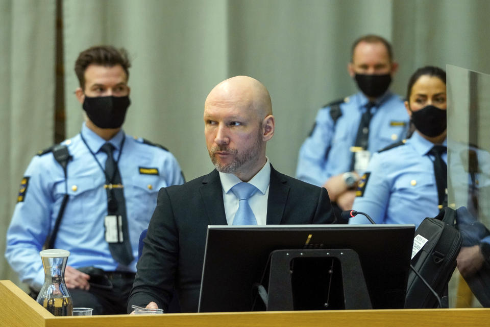 Norwegian mass killer Anders Behring Breivik sits in the makeshift courtroom in Skien prison on the second day of his hearing where he is requesting release on parole, in Skien, Norway, Wednesday, Jan. 19, 2022. Breivik, the far-right fanatic who killed 77 people in bomb-and-gun massacres in 2011, argued Tuesday for an early release from prison, telling a parole judge he had renounced violence even as he professed white supremacist views and flashed Nazi salutes. (Ole Berg-Rusten/NTB scanpix via AP)