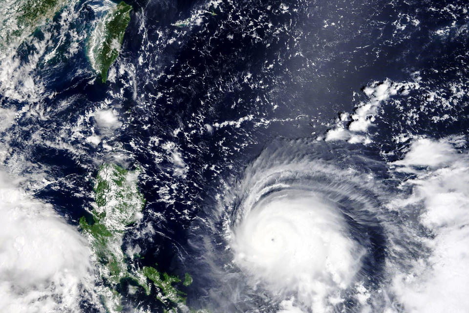 In this Thursday, Sept, 9, 2021, satellite image released by NASA, Typhoon Chanthu, right, develops into a powerful typhoon moving towards Taiwan, top left. Chanthu continues gaining strength and is expected to make landfall in Taiwan over the weekend. (NASA Worldview, Earth Observing System Data and Information System (EOSDIS) via AP)