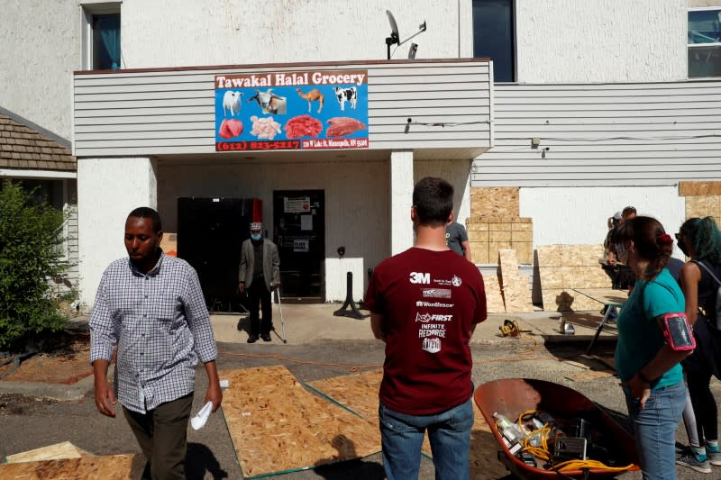 FILE PHOTO: Owner of Tawakal Halal Grocery store walks outside his store following the protests against the death in Minneapolis police custody of George Floyd, in Minneapolis