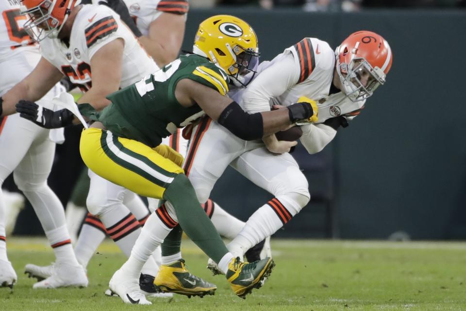Green Bay Packers' Rashan Gary sacks Cleveland Browns' Baker Mayfield during the first half of an NFL football game Saturday, Dec. 25, 2021, in Green Bay, Wis. (AP Photo/Aaron Gash)