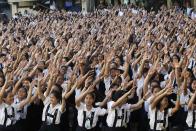 Thousands of students and faculty members dance to the theme song of the One Billion Rising campaign in the quadrangle of the St. Scholastica college in Manila February 14, 2013. One Billion Rising is a global campaign to call for an end to violence against women and girls, according to its organisers. REUTERS/Romeo Ranoco (PHILIPPINES - Tags: POLITICS SOCIETY EDUCATION)