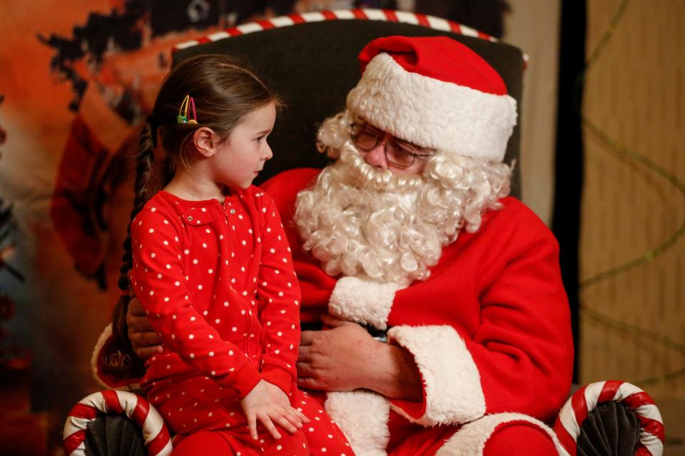 FILE - Harper Garcia, 4, sits on Santa's lap at Santa's North Pole in 2018.