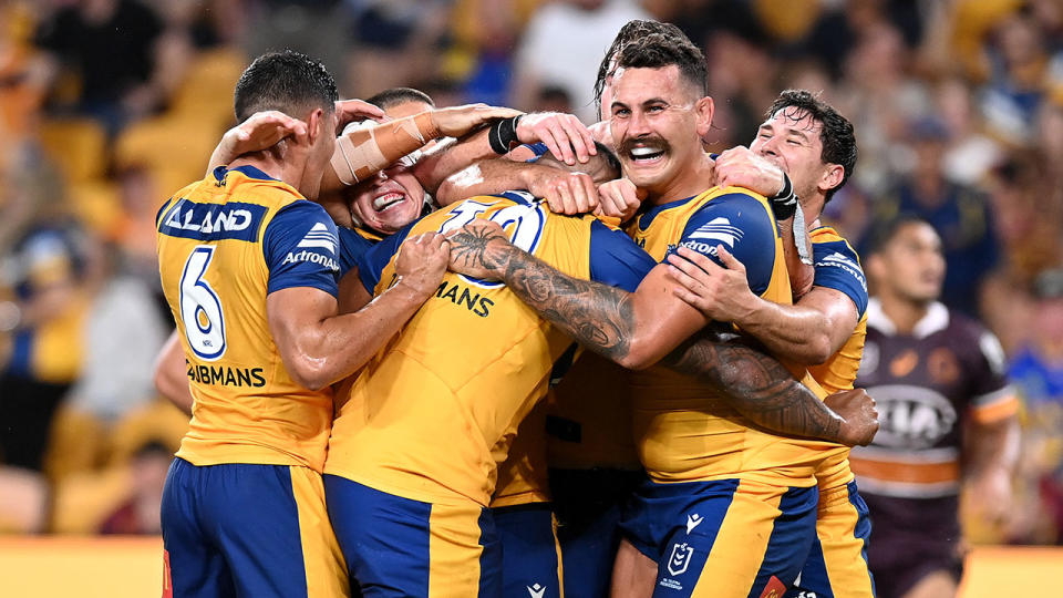 Seen here, Parramatta Eels players celebrate during the round one win over the Broncos. 