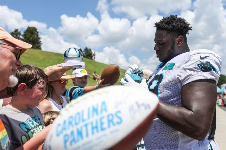 Panthers rookie tackle Ikem Ekwonu signs autographs for fans after training camp practice at Wofford College on Tuesday, August 9, 2022 in Spartanburg, SC.