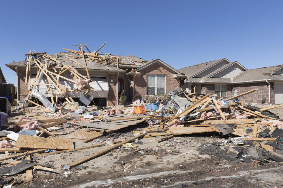 A home sits damaged along Frost Lane on Monday, Feb. 27, 2023 in Norman, Okla. The damage came after rare severe storms and tornadoes moved through Oklahoma overnight. (AP Photo/Alonzo Adams)