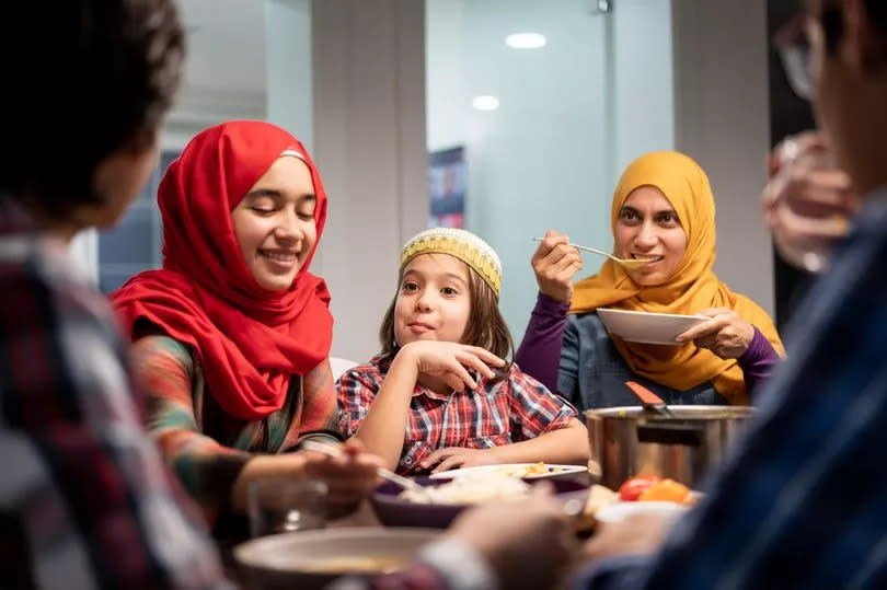 Family eating Iftar and enjoying breaking of fasting