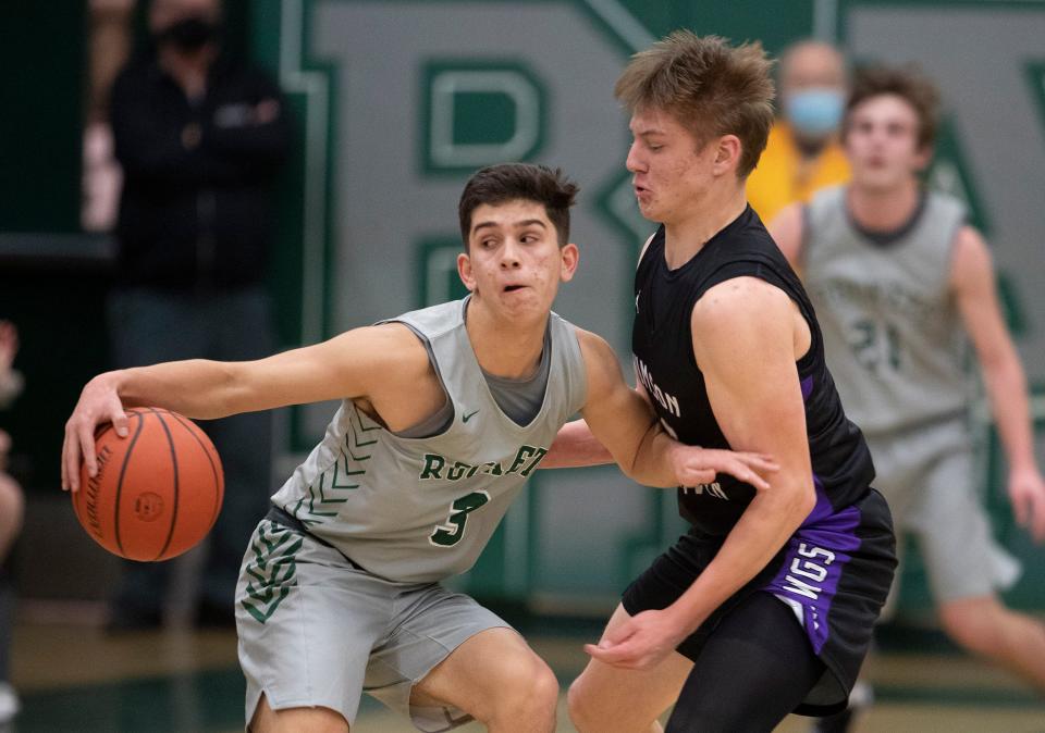 Raritan Justin Rivera spins to try and work around Rumson Owen Sullivan. Rumson-Fair Haven Boys Basketball defeats Raritan in Hazlet, NJ on January 20, 2022. 