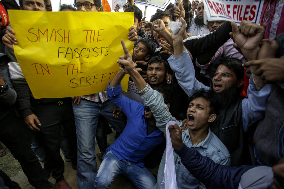 Indians shout slogans during a protest rally against the Citizenship Amendment Act, in Kolkata, India, Saturday, Dec. 21, 2019. Critics have slammed the law as a violation of India's secular constitution and have called it the latest effort by the Narendra Modi government to marginalize the country's 200 million Muslims. Modi has defended the law as a humanitarian gesture. Banner reads, withdraw CAA and NRC bills, join the rally and meeting. (AP Photo/Bikas Das)