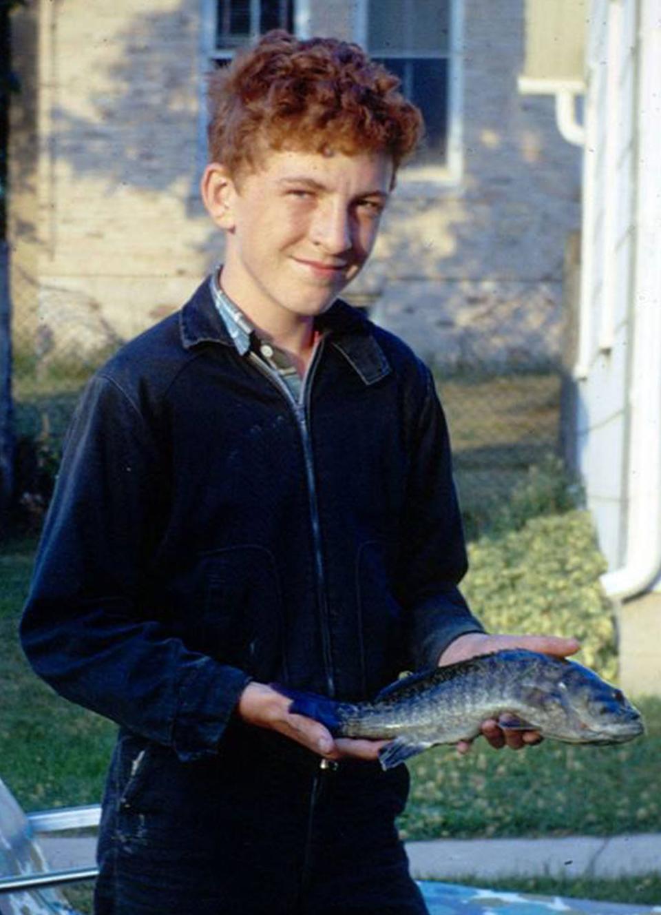Gary Klein holds a small mouth bass he caught on the Milwaukee River near Waubeka during the 1970s. The image was scanned from a Kodachrome transparency.