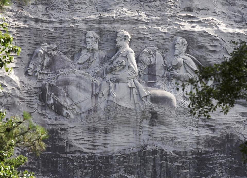 FILE - This June 23, 2015, file photo shows a carving depicting Confederate Civil War figures Stonewall Jackson, Robert E. Lee and Jefferson Davis, in Stone Mountain, Ga. The Stone Mountain Memorial Association has denied a gathering permit from the Sons of Confederate Veterans, who were looking to host their annual Confederate Memorial Day service at Stone Mountain Park outside Atlanta. The gathering was slated for Saturday, April 17, 2021, but a March 31 letter from memorial association CEO Bill Stephens denied the necessary permit, The Atlanta Journal-Constitution reported. (AP Photo/John Bazemore, File)