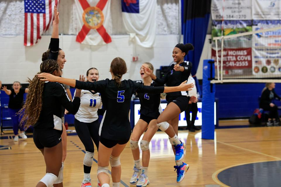 Trinity Christian's Mari King (23), Ariel Ross (9), Taylor Teaman (11), Ali Haney (5), Avery Haney (4) and Taelyn Graham (7) celebrate the Oct. 27 regional win against Providence.