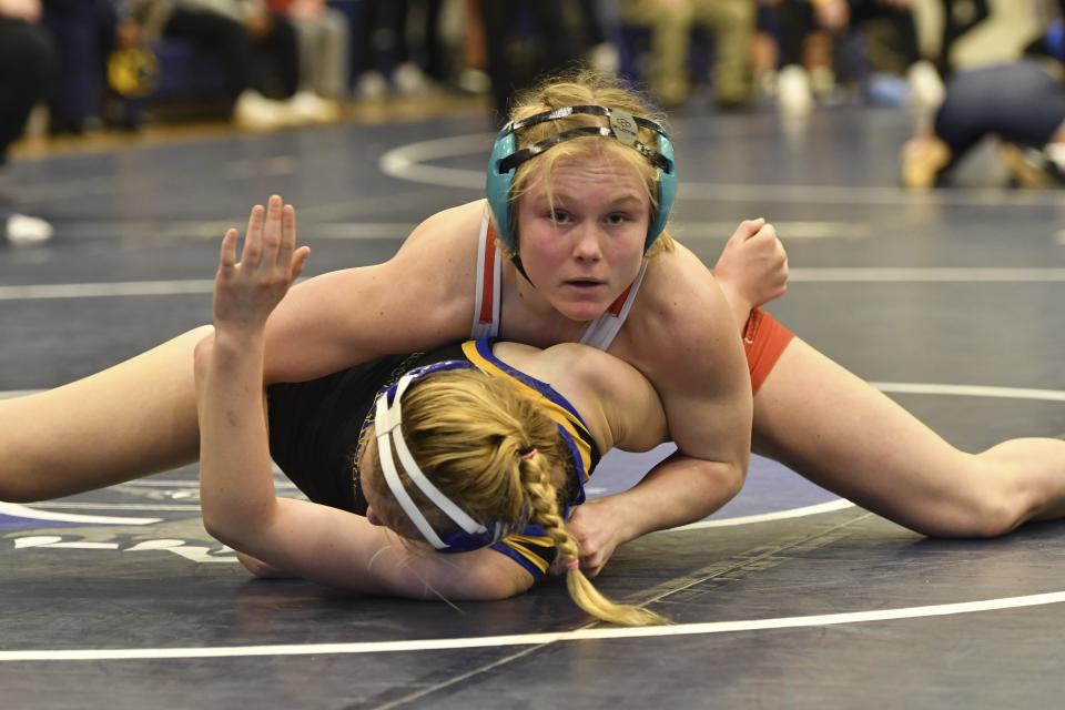 Easton Area High School wrestler Aubre Krazer, top, competes in a semifinal match during the Southeast Regional wrestling tournament Sunday, Feb. 25, 2024, in Quakertown, Pa. Girls’ wrestling has become the fastest-growing high school sport in the country. (AP Photo/Marc Levy)