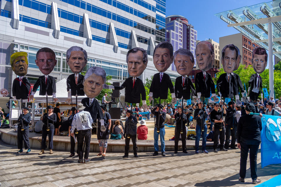 Past U.S. presidents are held up at a rally in Portland in support of a Supreme Court case in which young people are suing the federal government for failing to protect their right to a safe climate.&nbsp; (Photo: Icon Sportswire via Getty Images)