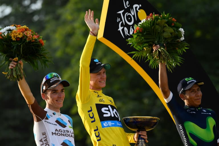 Tour de France winner Chris Froome, second-placed Romain Bardet (L), and third-placed Nairo Quintana on the podium on the Champs-Elysees avenue