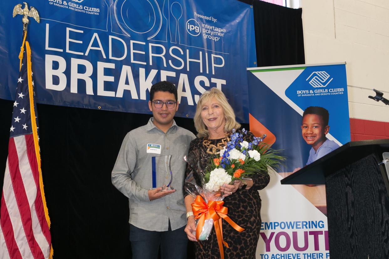 Suncoast Polytechnical High School freshman Gabriel C. presents the 2023 Leadership Award to Carol Butera, a nonprofit executive, at the 17th annual Boys & Girls Clubs of Sarasota and DeSoto Counties Leadership Breakfast.