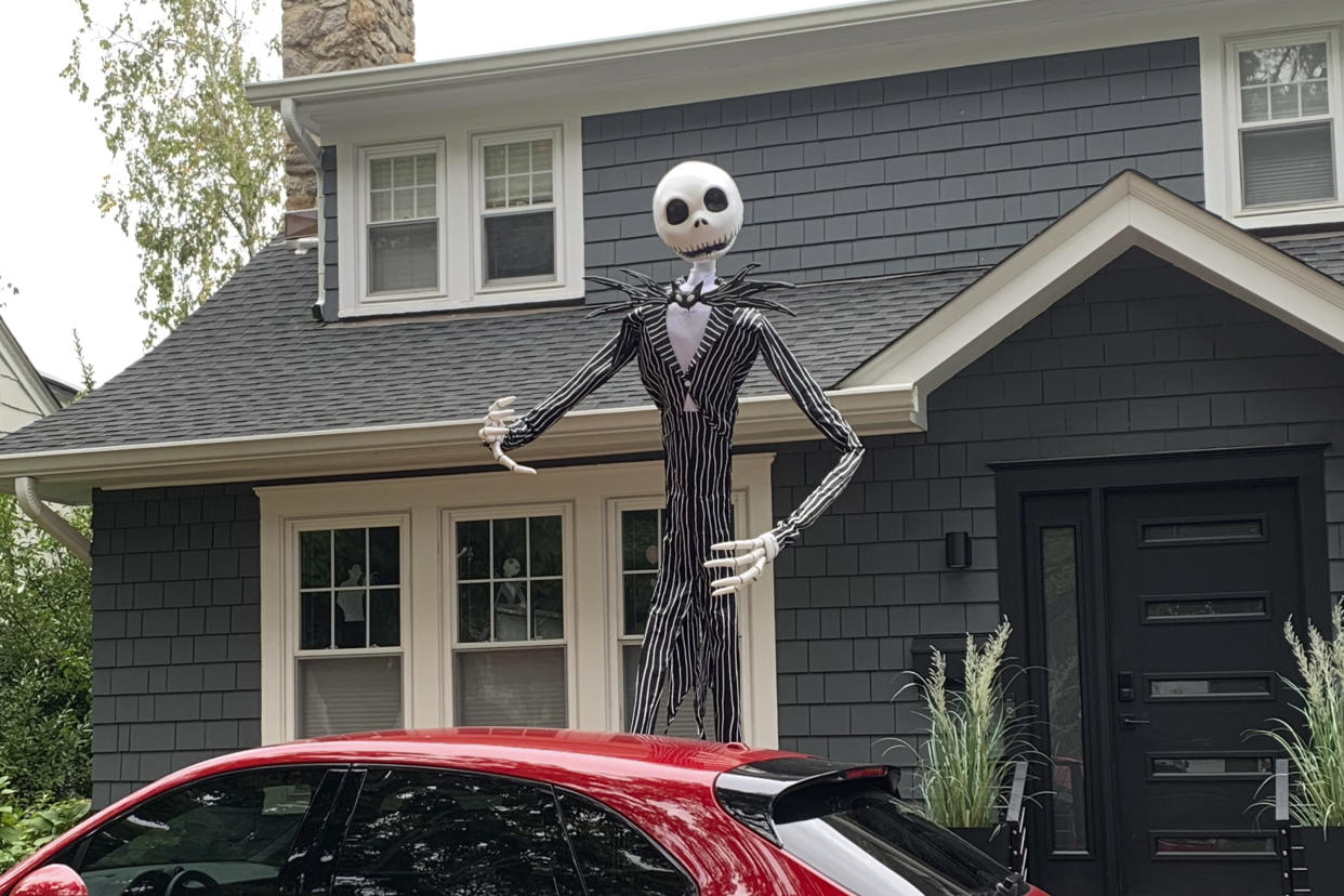 A towering figure of Jack Skellington from the film "The Nightmare Before Christmas" appears in front of a house in Westchester County, N.Y., on Sept. 23, 2024. The giant skeletons have upped the game on decorations, and Halloween superfans are thrilled. (AP Photo/Julia Rubin)