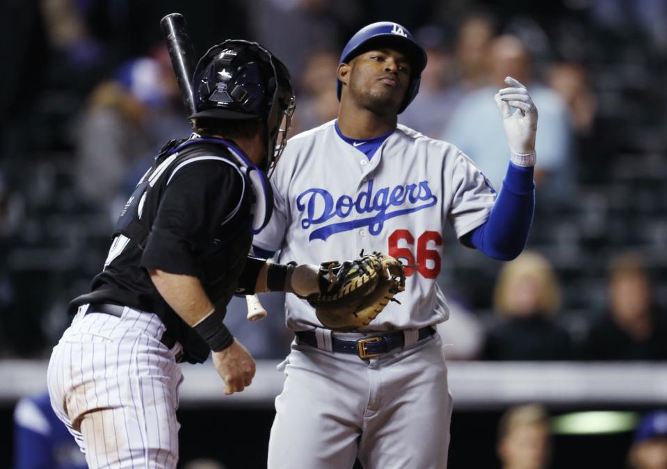 Yasiel Puig had a chance to keep the Dodgers' rally going, but couldn't solve Colorado's Greg Holland. (AP Photo/David Zalubowski)