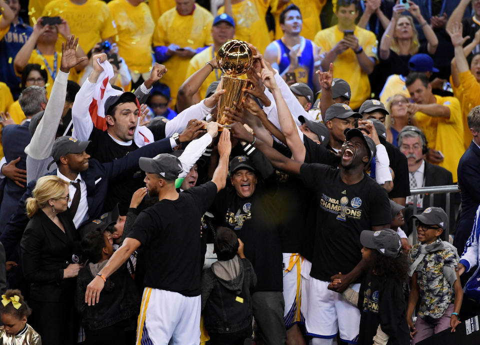 <p>JUN. 12, 2017 – Golden State Warriors players and coaches celebrate with the Larry O’Brien Trophy after defeating the Cleveland Cavaliers in game five of the 2017 NBA Finals at Oracle Arena. (Photo: Kyle Terada-USA TODAY Sports via Reuters) </p>