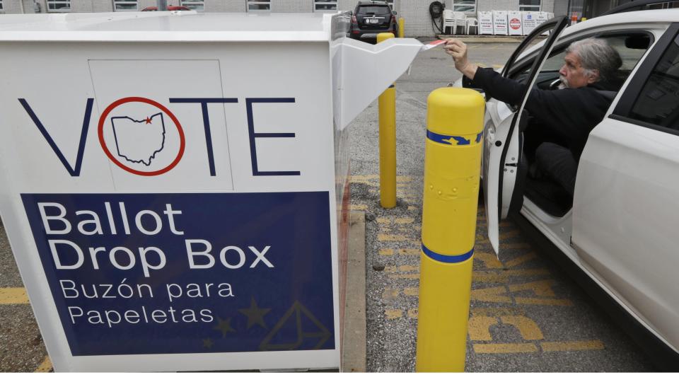 Jim O'Bryan drops of his election ballot in the drop box at the Cuyahoga County Board of Elections, Wednesday, April 22, 2020, in Cleveland.