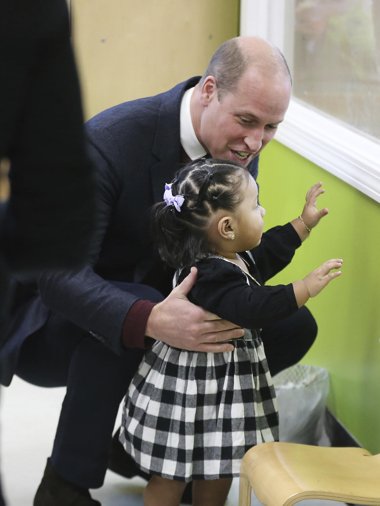 Britain's Prince William engages with 16-month-old Sofia during his visit to Roca on Thursday, Dec. 1, 2022, in Chelsea, Ma. (Nancy Lane/The Boston Herald via AP, Pool)