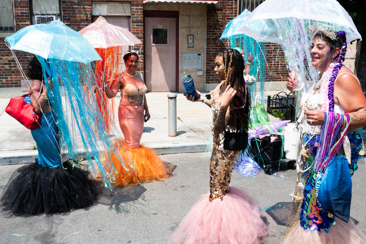 Participants prepare to march in the Mermaid Parade, along the Coney Island boardwalk in New York on Saturday, June 22, 2024. (Graham Dickie/The New York Times)