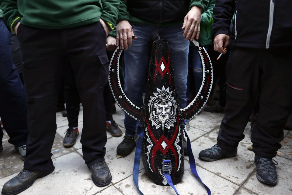 In this photo taken on Sunday, Jan. 19, 2020, a Jarramplas mask lies on the ground before the start of the Jarramplas festival in Piornal, Spain.The Jarramplas festival features a man in multicolored garb and pointy wooden headgear to shield himself from turnips. A crowd of men in the street pelt the man with the vegetables from close range at the fiesta held annually at Piornal, 200 kilometers west of Madrid, over two days. (AP Photo/Manu Fernandez)