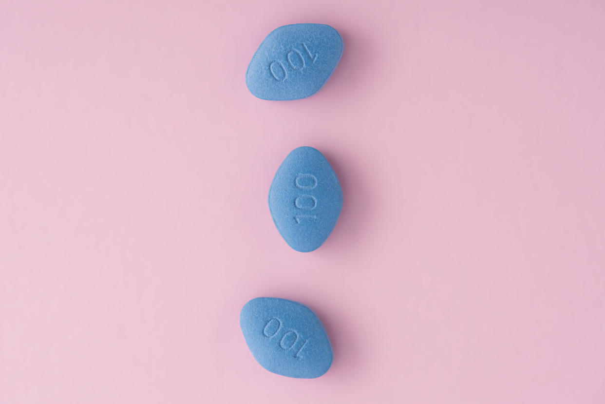 Blue pills viagra on pink background. Top view. Medicine concept of medication for potency, erection, treatment of erectile dysfunction, pulmonary hypertension