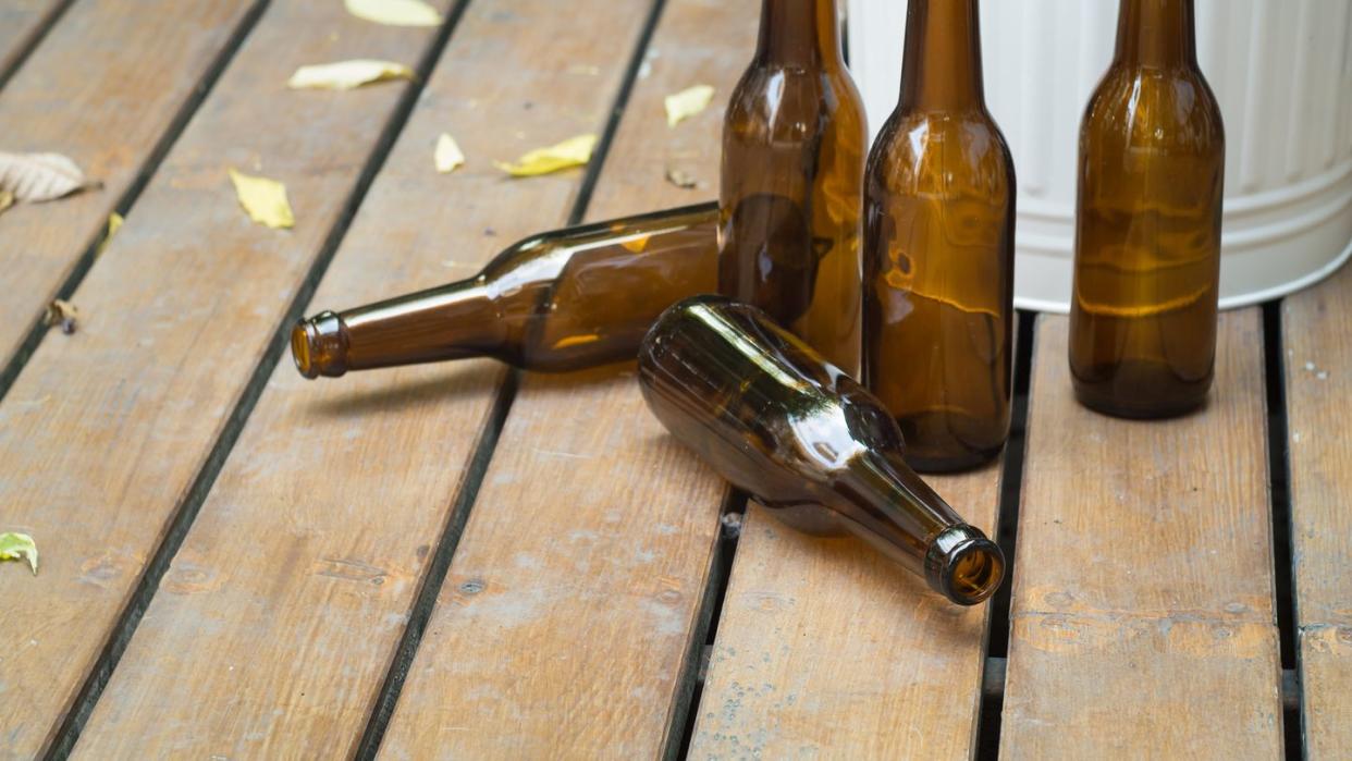 bottles and bin on rustic wooden floor