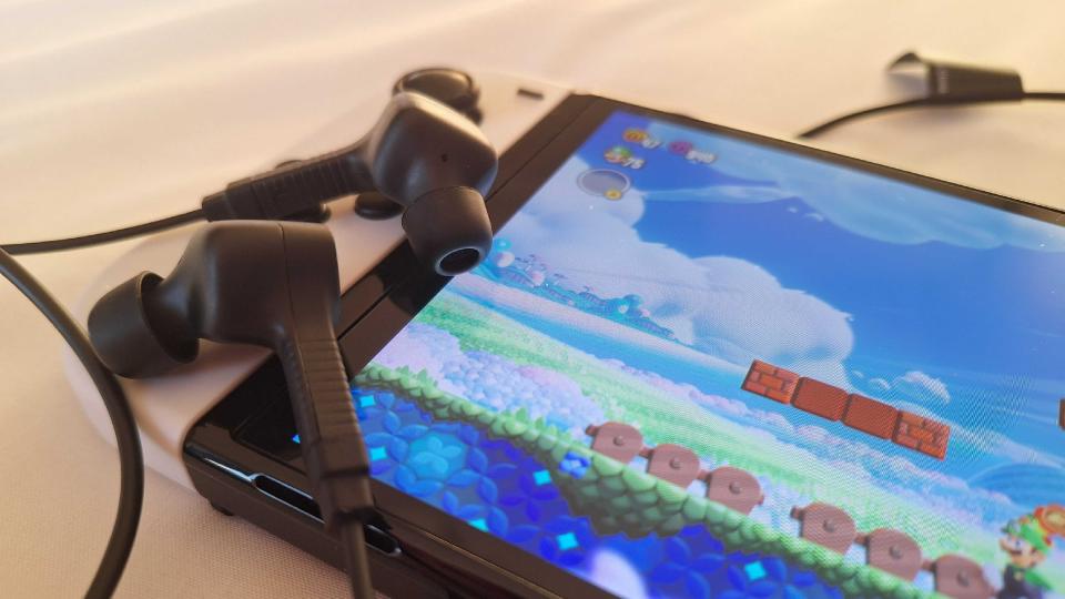 Roccat Syn Buds Core plugged into a white Nintendo Switch OLED model.