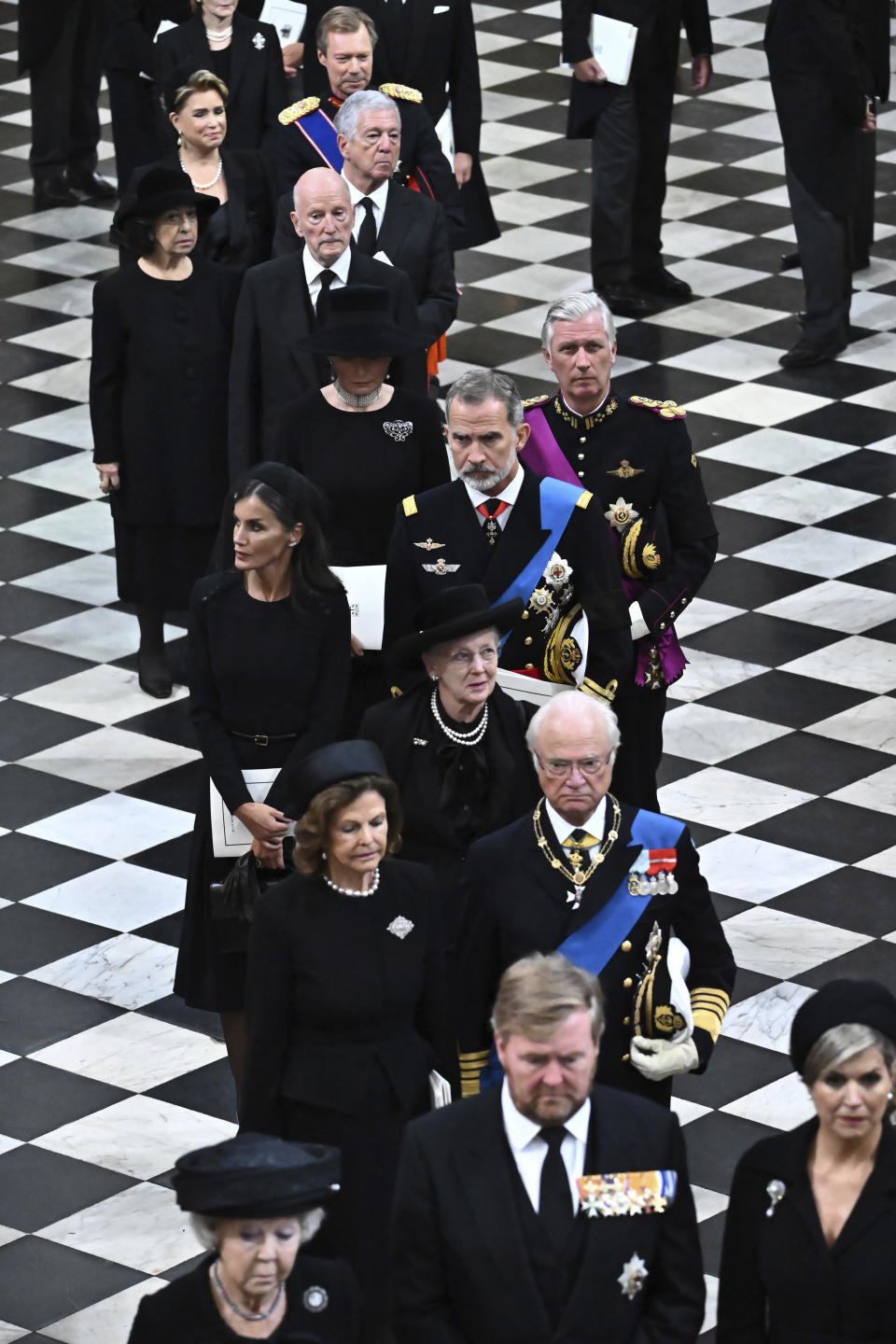 FILE - Netherlands' King Willem-Alexander, lower center, Queen Maxima, lower right, and former queen Beatrix, lower left, Sweden's Queen Silvia, 2nd row left, and King Carl Gustav XVI, 2nd row right, Denmark's Queen Margrethe II, center, Spain's King Felipe VI, center right, and Queen Letizia, Queen Mathilde of Belgium, 5th row left, and King Philippe, 5th row right, attend the funeral of Queen Elizabeth II in Westminster Abbey in central London, Monday Sept. 19, 2022. Denmark’s Queen Margrethe II has tested positive for the coronavirus after attending the funeral of Britain’s Queen Elizabeth II. The Danish royal palace said Wednesday, Sept. 21, 2022 that the 82-year-old Margrethe canceled her official duties after the Tuesday night test. she previously tested positive for the virus in February. (Ben Stansall/Pool via AP, File)
