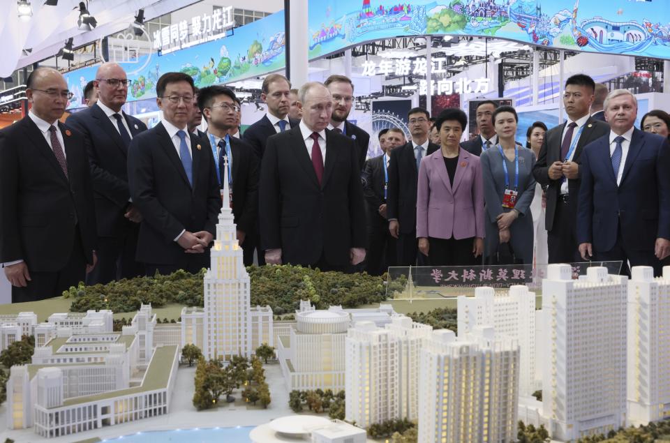 Russian President Vladimir Putin, center, and Chinese Vice President Han Zheng, left of Putin, visit an exhibition of the Russia-China Expo and the Russia-China Forum on Interregional Cooperation in Harbin, northeastern China's Heilongjiang Province, on Friday, May 17, 2024. (Sergei Bobylev, Sputnik, Kremlin Pool Photo via AP)