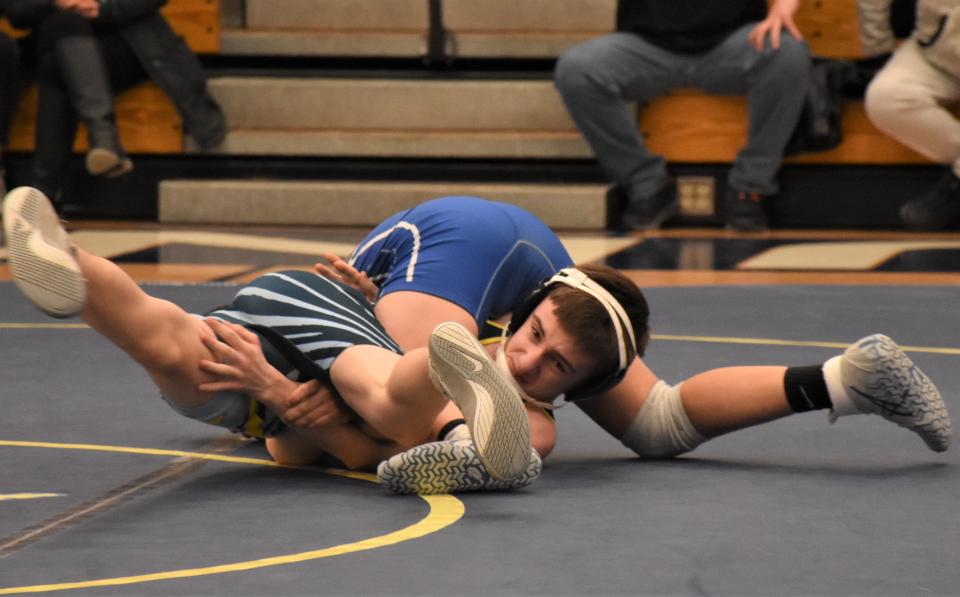 Central Valley Aacdemy's Matt Osley (facing camera) gets tangled up with Camden Bue Devil Talon Kimball during the first period of Wednesday's 110-pound bout in Ilion.