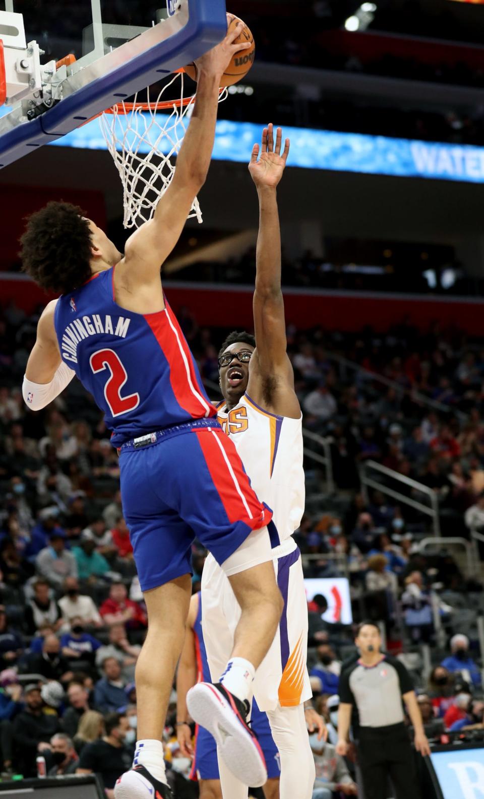 Detroit Pistons guard Cade Cunningham dunks against Phoenix Suns forward Jalen Smith on Sunday, Jan. 16, 2022 at Little Caesars Arena.