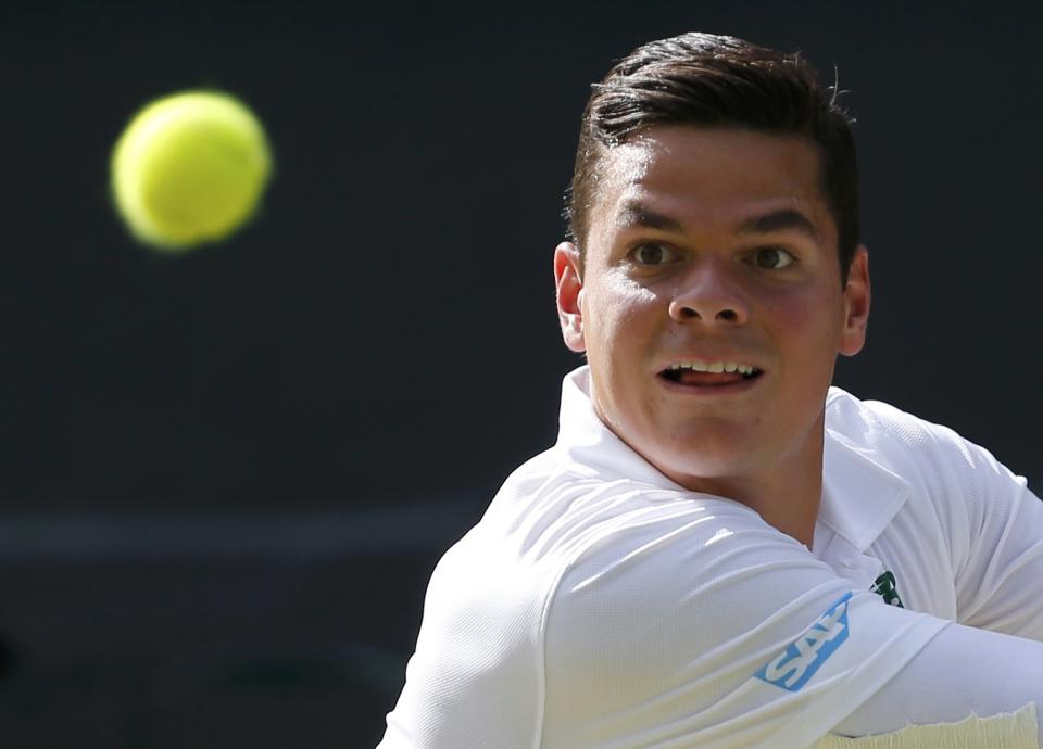 Milos Raonic of Canada hits a return during his men's singles semi-final tennis match against Roger Federer of Switzerland at the Wimbledon Tennis Championships, in London July 4, 2014. REUTERS/Stefan Wermuth (BRITAIN - Tags: SPORT TENNIS)