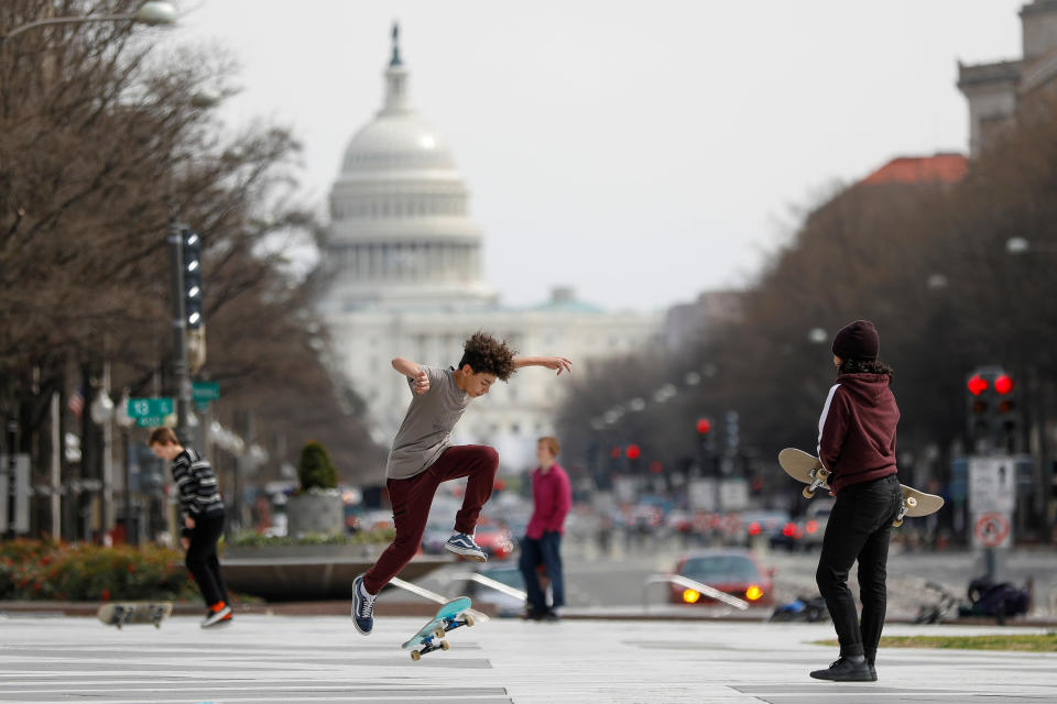 Kids perform skateboard tricks at Freedom Plaza, as Mayor Muriel Bowser declared a State of Emergency due to the coronavirus disease (COVID-19) in Washington, U.S., March 16, 2020. REUTERS/Tom Brenner     TPX IMAGES OF THE DAY