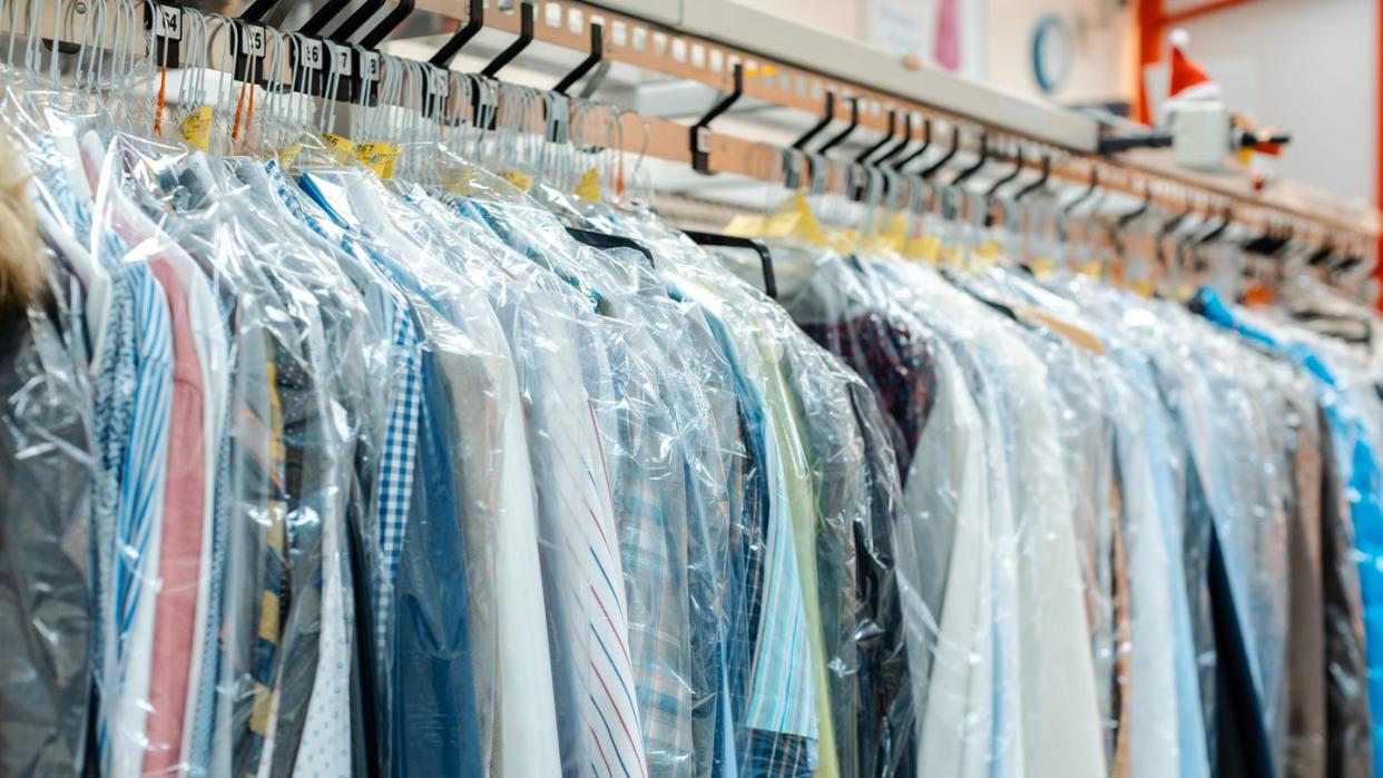 carousel of clothing waiting for pick up in dry cleaning shop