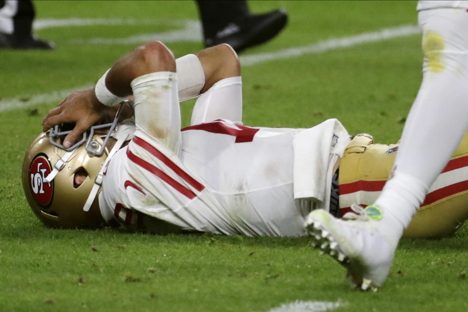 San Francisco 49ers quarterback Jimmy Garoppolo lays on the ground after being hit during the second half of the NFL Super Bowl 54 football game against the Kansas City Chiefs Sunday, Feb. 2, 2020, in Miami Gardens, Fla. (AP Photo/Matt York)