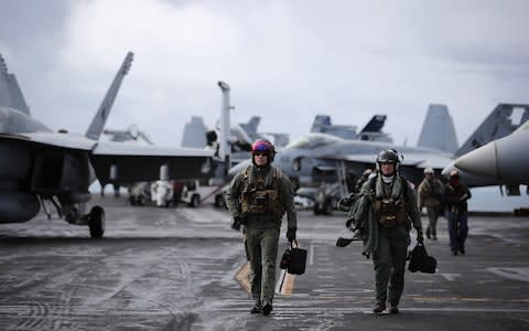 F/A-18 Hornet pilots return from a flight during joint military exercise, Saxon Warrior, aboard the USS George H.W. Bush on August 6, 2017 off the north west coast of the United Kingdom - Credit: Getty Images Europe/ Dan Kitwood