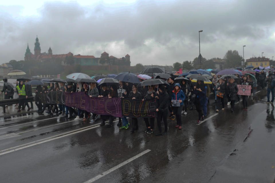 Pro-abortion rights protesters march in the rain on Krakow's Debnicki Bridge en route&nbsp;to the main&nbsp;square.&nbsp;